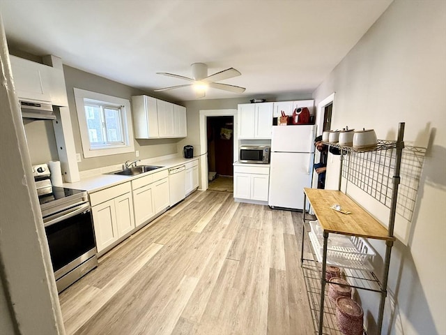 129 Eastern Ave, Springfield, MA 01109 - kitchen with light wood-style flooring, ceiling fan, appliances with stainless steel finishes, under cabinet range hood, and a sink