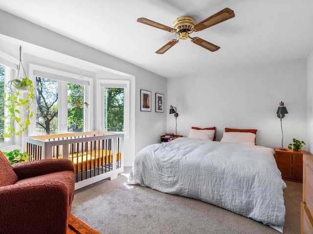 carpeted bedroom featuring a ceiling fan