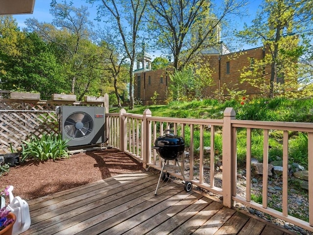 wooden terrace featuring a grill and ac unit