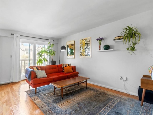 living area with wood finished floors and baseboards