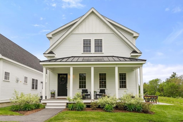 9 Baldwin Ct Unit 9, Harvard, MA 01451 - view of front of home featuring a standing seam roof, a porch, board and batten siding, and metal roof