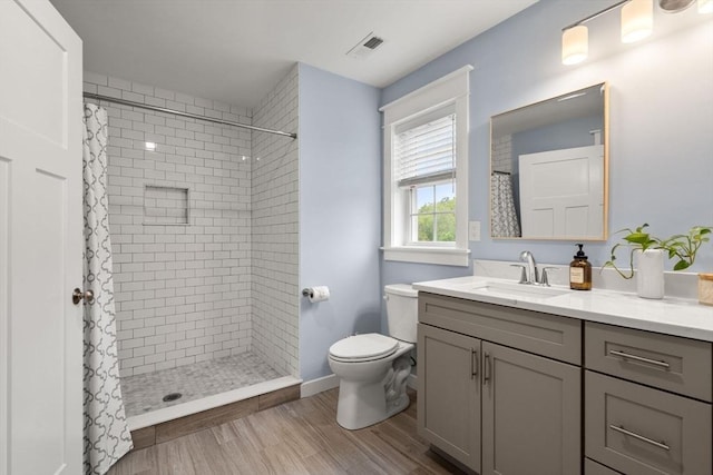 9 Baldwin Ct Unit 9, Harvard, MA 01451 - bathroom featuring vanity, toilet, a tile shower, wood finished floors, and baseboards