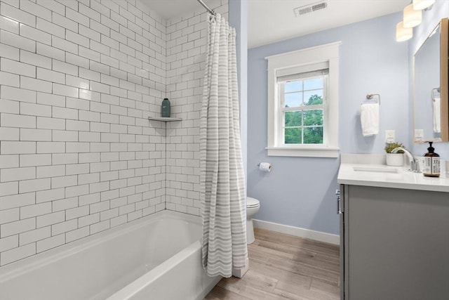9 Baldwin Ct Unit 9, Harvard, MA 01451 - full bath featuring vanity, toilet, shower / bath combo with shower curtain, wood finished floors, and baseboards