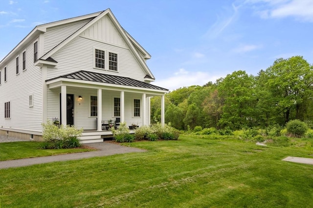 9 Baldwin Ct Unit 9, Harvard, MA 01451 - view of front of home with covered porch, a standing seam roof, and a front lawn