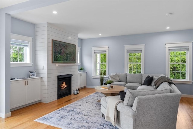 9 Baldwin Ct Unit 9, Harvard, MA 01451 - living area featuring healthy amount of natural light, a large fireplace, light wood finished floors, recessed lighting, and baseboards