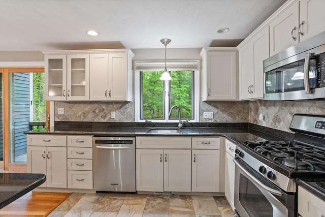 16 Deer Path Unit 1, Maynard, MA 01754 - kitchen featuring stainless steel appliances, a sink, glass insert cabinets, backsplash, and white cabinetry