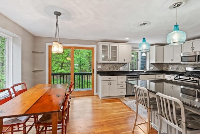 16 Deer Path Unit 1, Maynard, MA 01754 - kitchen featuring appliances with stainless steel finishes, a sink, dark countertops, and white cabinetry
