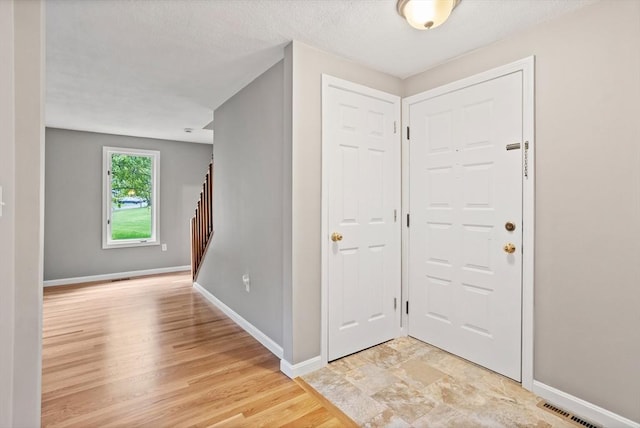16 Deer Path Unit 1, Maynard, MA 01754 - foyer with baseboards, light wood-style floors, and stairway