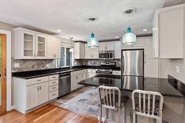 16 Deer Path Unit 1, Maynard, MA 01754 - kitchen featuring appliances with stainless steel finishes, white cabinetry, a sink, decorative backsplash, and recessed lighting