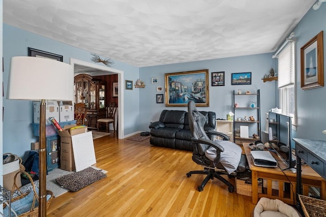 office with light wood-type flooring and baseboards