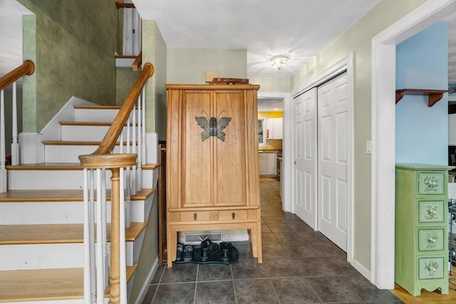 mudroom with dark tile patterned flooring and visible vents