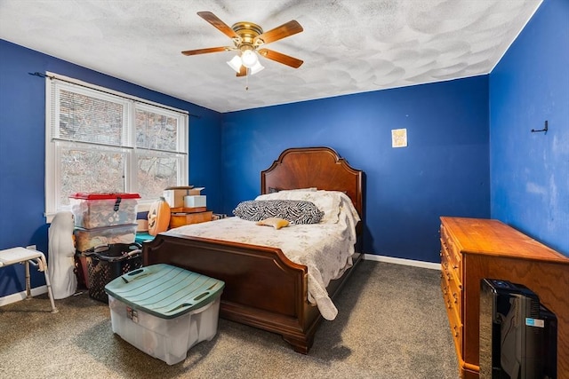 carpeted bedroom with ceiling fan, baseboards, and a textured ceiling