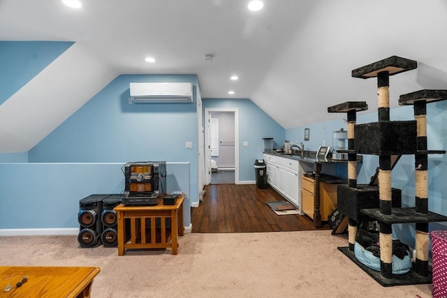 additional living space featuring lofted ceiling, recessed lighting, baseboards, and a wall mounted air conditioner