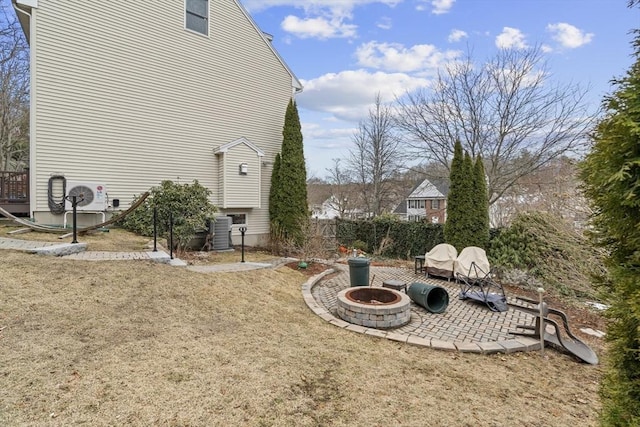 view of yard with a fire pit, a patio, and cooling unit