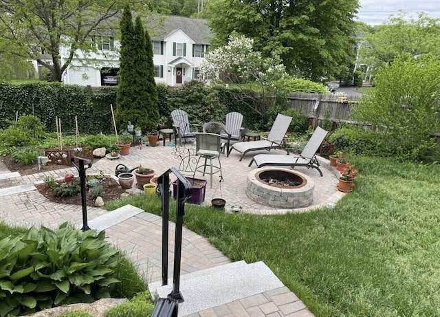 exterior space with a patio area, fence, and a fire pit