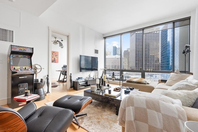 living room featuring light hardwood / wood-style floors and a wall of windows