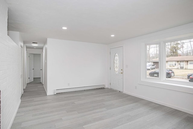 foyer entrance with light hardwood / wood-style floors and baseboard heating