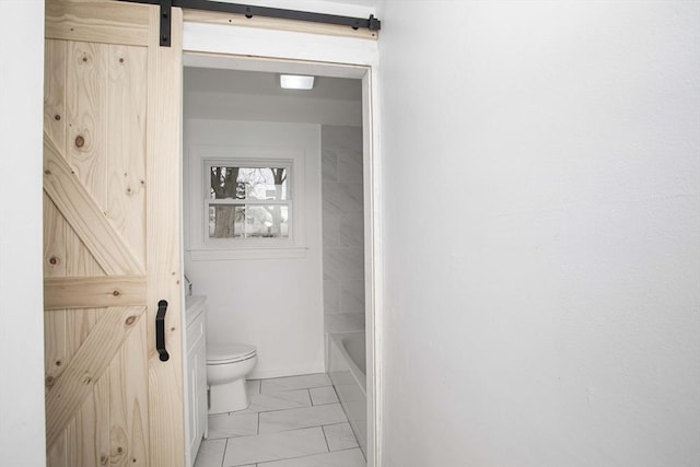 bathroom with tile patterned flooring, toilet, and a tub