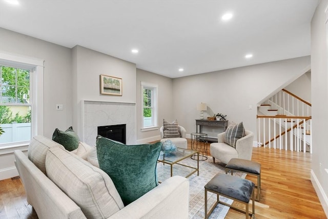 89 Wildwood St, Winchester, MA 01890 - living area featuring light wood-style flooring, a premium fireplace, stairway, and recessed lighting