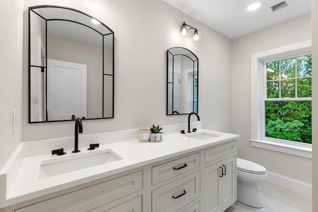 89 Wildwood St, Winchester, MA 01890 - bathroom with double vanity and toilet