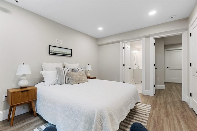 89 Wildwood St, Winchester, MA 01890 - bedroom featuring light wood finished floors, recessed lighting, and ensuite bath