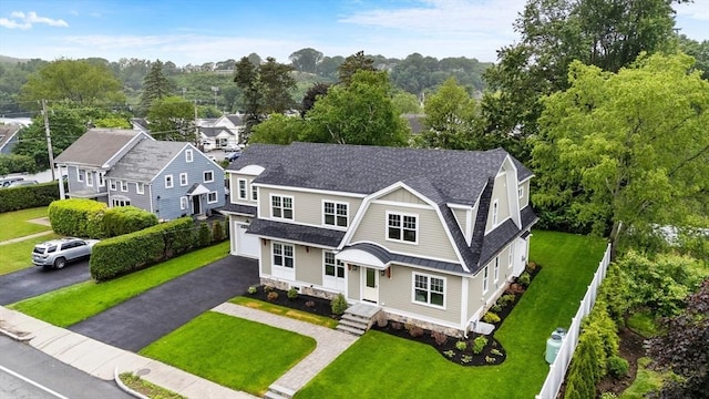 89 Wildwood St, Winchester, MA 01890 - shingle-style home featuring roof with shingles, a gambrel roof, a front lawn, and driveway