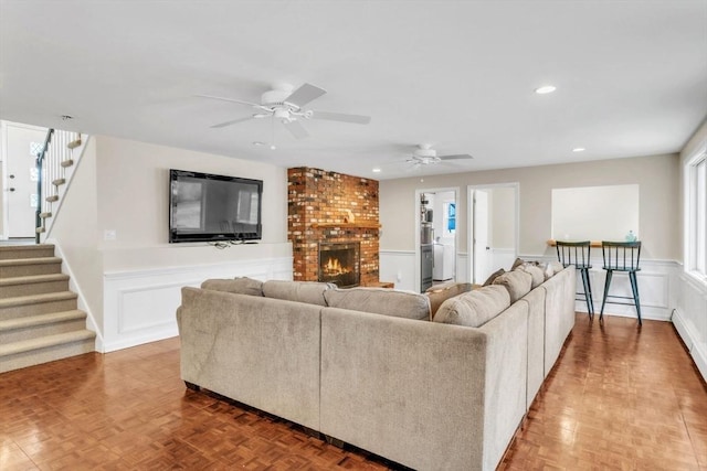 living room with a brick fireplace and parquet floors