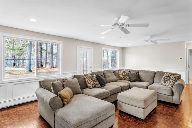 living room featuring dark parquet flooring and a baseboard heating unit