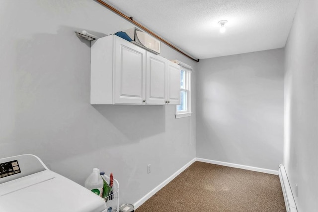 clothes washing area with a baseboard radiator, washer / dryer, carpet floors, cabinets, and a textured ceiling