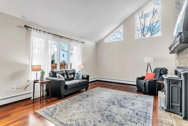 living room featuring baseboard heating, plenty of natural light, and wood-type flooring