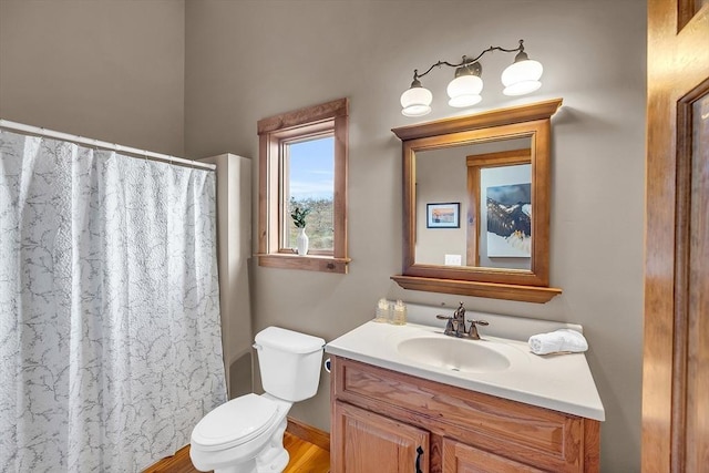 bathroom featuring a shower with shower curtain, vanity, wood-type flooring, and toilet