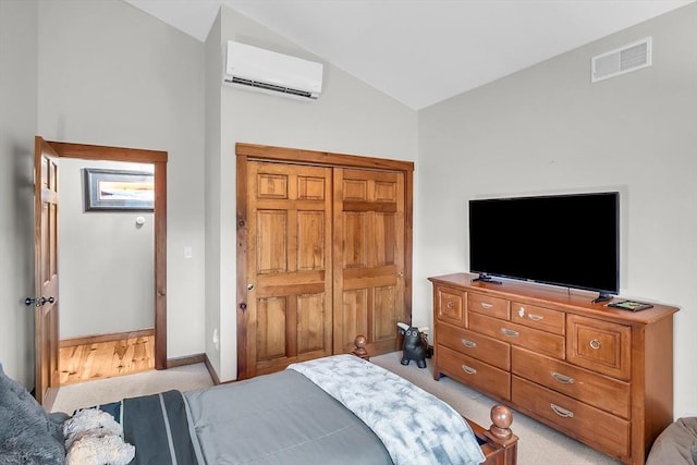 carpeted bedroom featuring an AC wall unit and vaulted ceiling