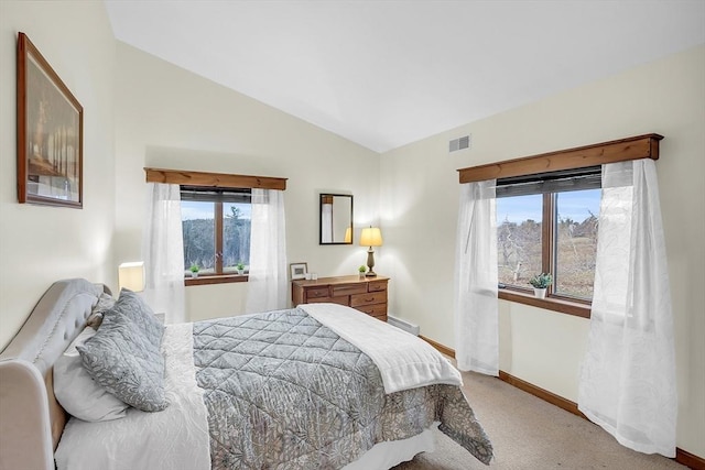 carpeted bedroom featuring multiple windows and vaulted ceiling