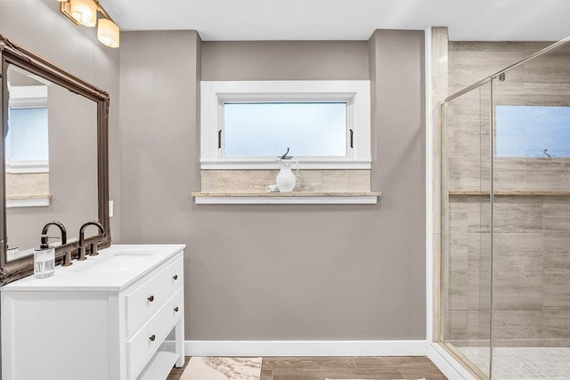 bathroom with plenty of natural light, vanity, and walk in shower