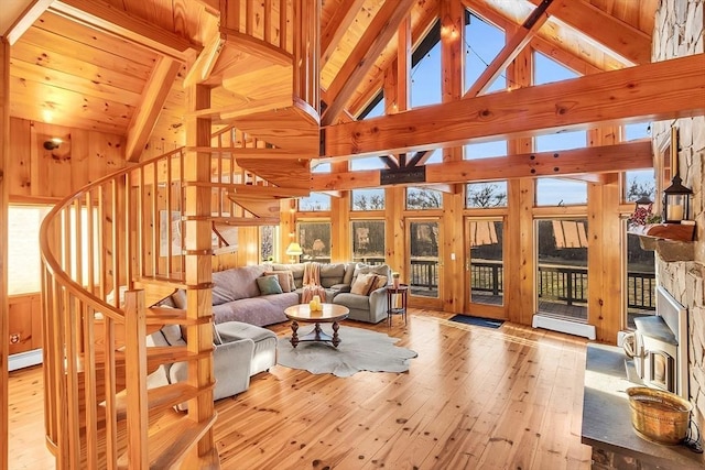 living room featuring beamed ceiling, high vaulted ceiling, a baseboard heating unit, and light wood-type flooring