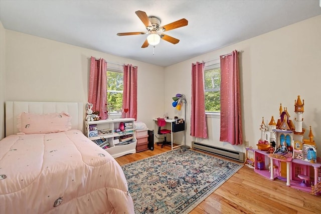 148 Prince Rd, Southbridge, MA 01550 - bedroom featuring baseboard heating, multiple windows, wood finished floors, and a ceiling fan