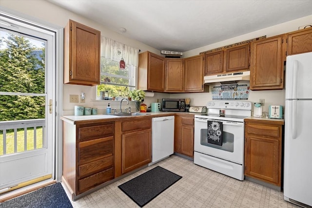 148 Prince Rd, Southbridge, MA 01550 - kitchen featuring white appliances, under cabinet range hood, a sink, and brown cabinets