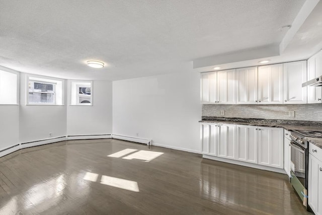 kitchen with backsplash, white cabinetry, high end range, and dark wood-type flooring