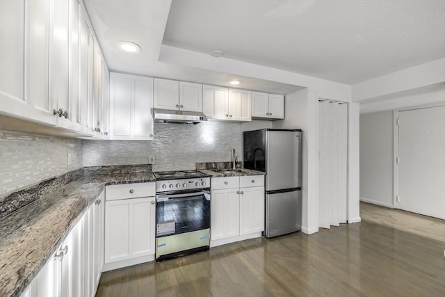 kitchen with dark stone countertops, sink, white cabinets, and appliances with stainless steel finishes