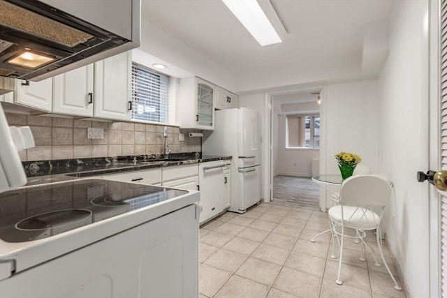 kitchen with white appliances, extractor fan, white cabinetry, backsplash, and light tile patterned flooring