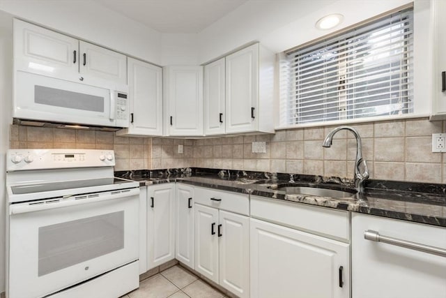 kitchen featuring white appliances, a sink, white cabinetry, and tasteful backsplash