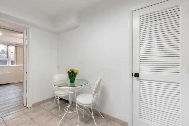 dining room with light tile patterned floors and baseboards