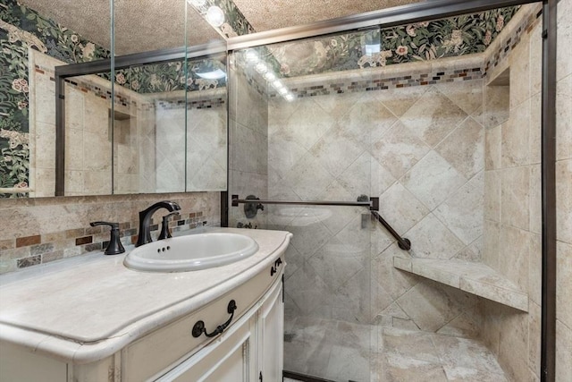 full bath featuring a stall shower, backsplash, and vanity