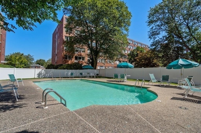 community pool featuring a patio area and fence