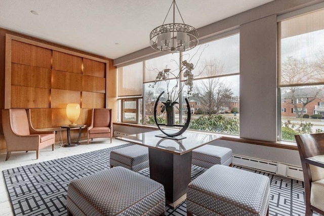 interior space with a chandelier and a baseboard heating unit