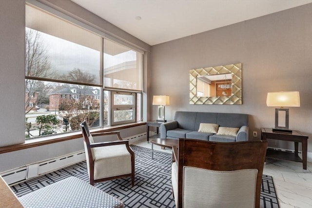 living area featuring a baseboard radiator and baseboards