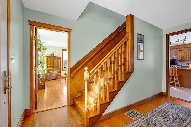 stairway featuring wood-type flooring