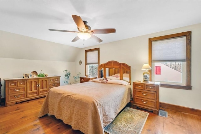 bedroom with lofted ceiling, ceiling fan, and light hardwood / wood-style floors