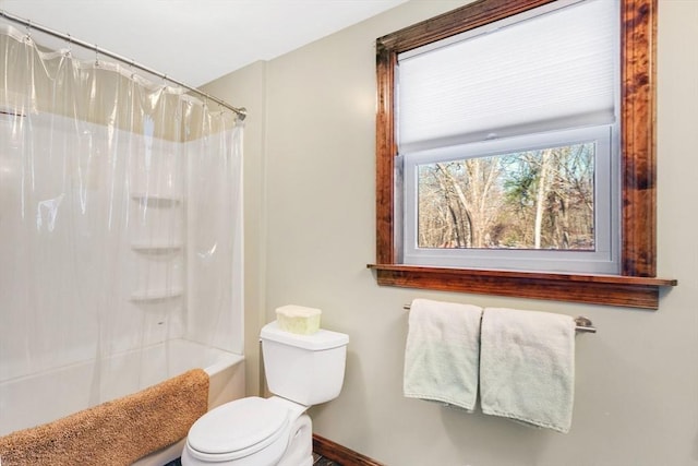 bathroom with shower / bath combo and toilet