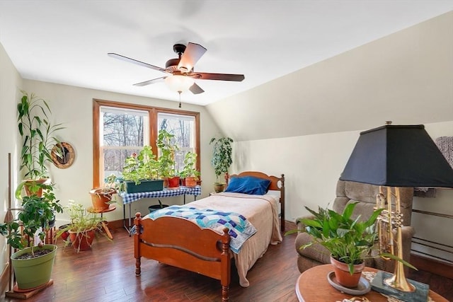 bedroom featuring ceiling fan, dark wood-type flooring, and vaulted ceiling